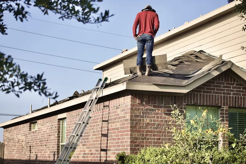 Professional roofer working on a residential roof in Lawn Acres